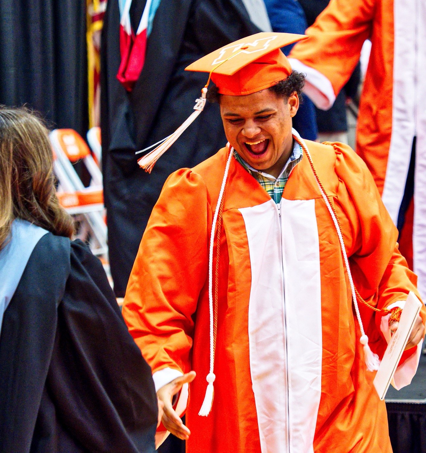 Nate Griffin exuberantly exits the stage after receiving his diploma. [observe more orange, get grad gifts]